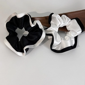 Ensemble de chouchous en satin noir et blanc élégants avec texture soyeuse et brillante