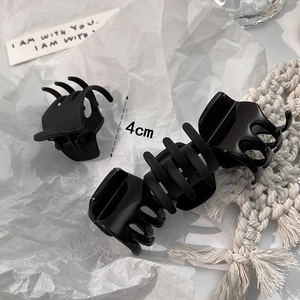 Minimalist 4cm black hair claw clips in matte and glossy finishes for ponytails