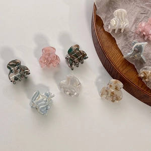 Mini acetate hair claw clips in assorted marble and tortoiseshell patterns for women