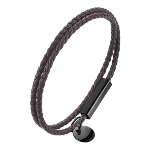 Macro view of double braided brown leather bracelet with black magnetic clasp and metal tag