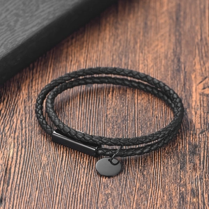 Close-up of black double-layered braided leather bracelet with metallic magnetic clasp