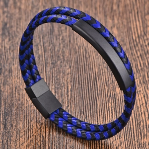 Men's double-layered braided leather bracelet with black magnetic clasp on wood background