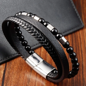 Detail of multi-layer men's leather bracelet with silver magnetic clasp and black beads