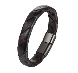 Macro detail of men's braided leather bracelet with grey metal magnetic clasp