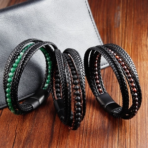 Macro detail of braided leather bracelets with natural stone beads and matte magnetic clasp
