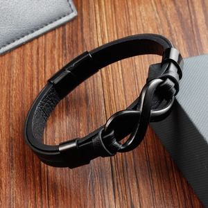 Men's black braided leather bracelet with matte black infinity symbol on wood background