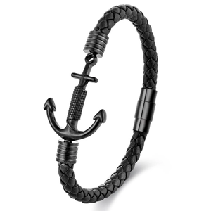 Macro view of men's black braided leather bracelet with a matte black anchor clasp closure