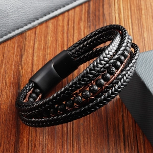 Detail of multi-layer black braided leather bracelet with lava beads and matte magnetic clasp