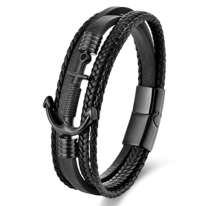 Detail of multi-layer black braided leather bracelet with metal anchor and magnetic clasp