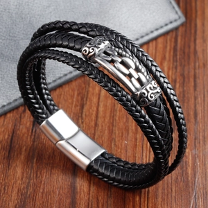 Detail of multi-layer black braided leather bracelet with vintage silver magnetic clasp