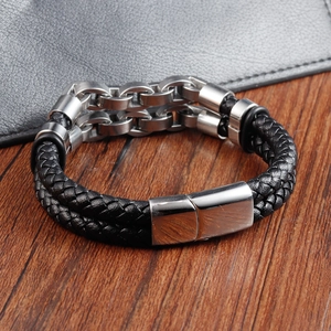 Detail of black braided leather bracelet with silver stainless steel chain and magnetic clasp