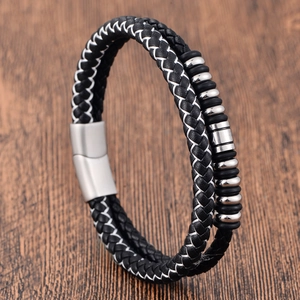 Detail of double-layer woven leather bracelet with metal beads and magnetic clasp