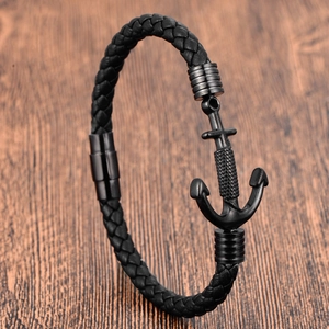 Men's double-layered black woven leather bracelet with black anchor clasp on wooden surface