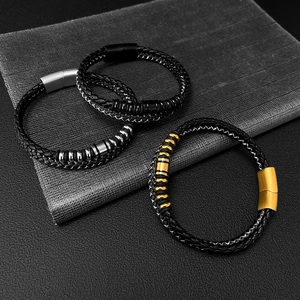 Close-up of triple braided leather bracelets with gold, silver and black magnetic clasps