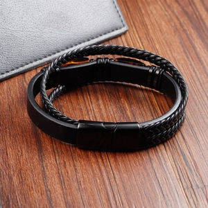 Macro detail of men's leather bracelet with yellow tiger eye stones and black steel clasp
