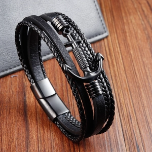 Detail of multi-layer black leather bracelet with matte black anchor charm and magnetic clasp