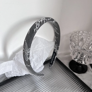 Elegant vintage lace sponge headband in black and grey with handmade brand tag details