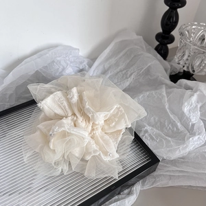 Elegant cream mesh scrunchie with layered lace and pearls in a soft aesthetic scene