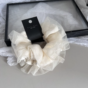 Detail of cream oversized tulle scrunchie with premium mesh layers and tag in Korea style