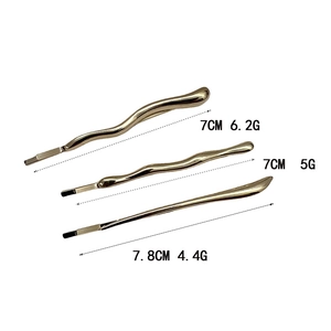 Set of three irregular gold alloy hair clips featuring wavy and smooth minimalist designs