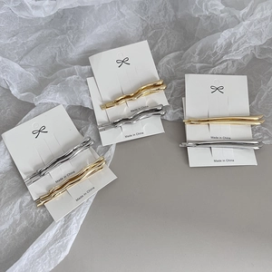 Minimalist metallic alloy hair pin set in gold and silver tones on display cards