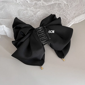Elegant black satin bow hair claw clip with golden crystal droplets and 6cm grip