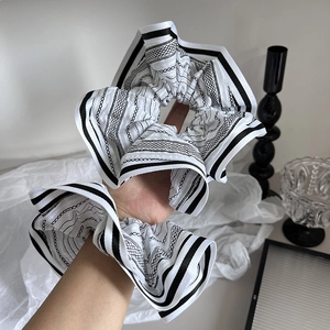 Elegant black and white striped scrunchies set worn on wrist for a stylish look