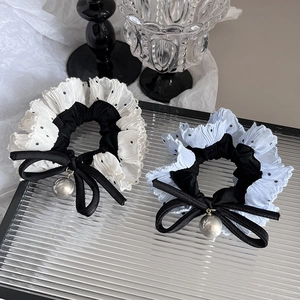 Detail of polka dot lace scrunchies with satin bows and large silver pearl pendants