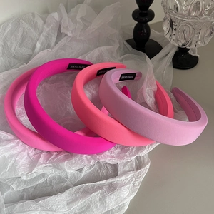 Macro shot of colorful padded sponge headbands with handmade labels in four pastel tones