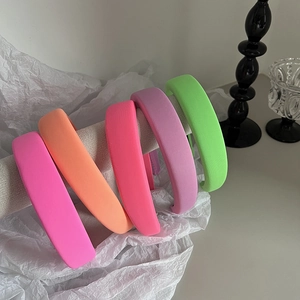 Five-piece set of thick padded sponge headbands in vibrant neon colors and matte fabric