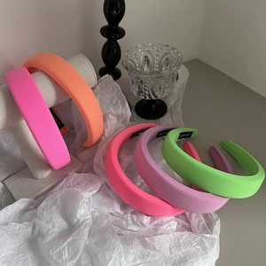 Detail view of colorful padded handmade headbands in satin finish for hair styling