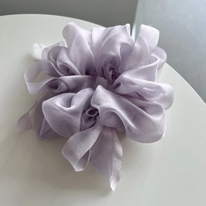 Detail of light purple sheer mesh scrunchie with voluminous pleats and pearlescent finish