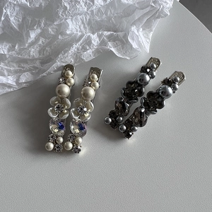 Detailed view of 4-piece hair clip set with faux pearls, crystals, and floral motifs