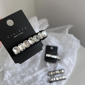Detail of K9 crystal snap hair clip with rectangular rhinestones on a black base