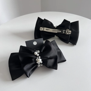 Elegant black double-layer satin bow hair clip with white pearls and a silver spring clip