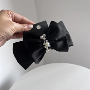 Elegant large black satin double bow hair clip with white pearl accents on back card