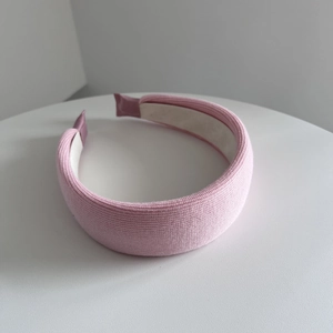 Close-up of pink padded sponge headband with textured fabric and soft inner lining