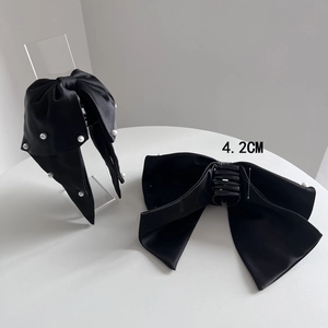 Elegant black satin bow hair claw with pearls for women, minimalist fashion accessory
