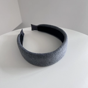 Detailed view of dark grey knitted fabric texture on high-profile headband with inner lining