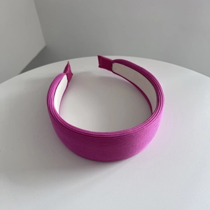 Dettaglio del cerchietto in spugna viola rosa con trama a costine e fodera interna bianca