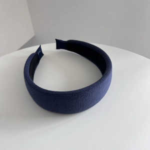 Detail view of navy blue knitted headband with textured fabric and non-slip lining