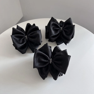 Ensemble de trois barrettes nœuds noirs satinés à paillettes avec détails en strass