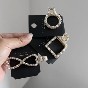Three-piece set of pearl and rhinestone hair clips in geometric gold metal designs