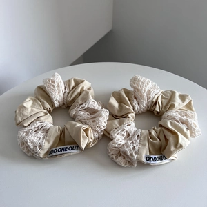 Handmade cotton scrunchie set with beige fabric, white lace, and embroidered stitching