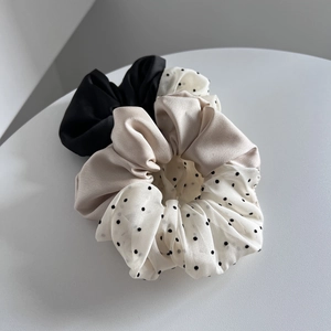 Three-piece scrunchie set in black satin, champagne gold, and white polka dot chiffon