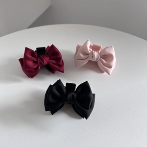 Three-piece set of elegant matte fabric bow hair claws in burgundy, pink, and black