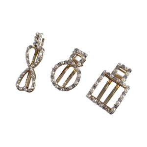 Three-piece set of elegant gold metal hair clips with faux pearls and rhinestones