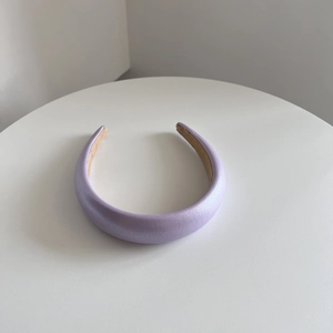 Detail of light purple sponge headband with matte pearlescent faux leather finish