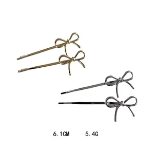 Set of four gold and silver metal bow hair clips for women with elegant metallic finish