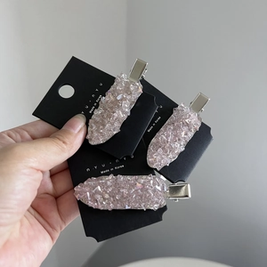 Pink crystal hair clips set with silver metal duckbill base on black card holder